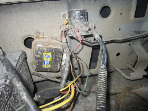 1982 Ford Bronco - Close-up of engine bay electrical components including a NAPA voltage regulator and wiring.