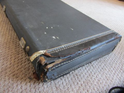 1968 Ford Mustang - This vintage guitar case shows significant wear and tear on its corners and edges.