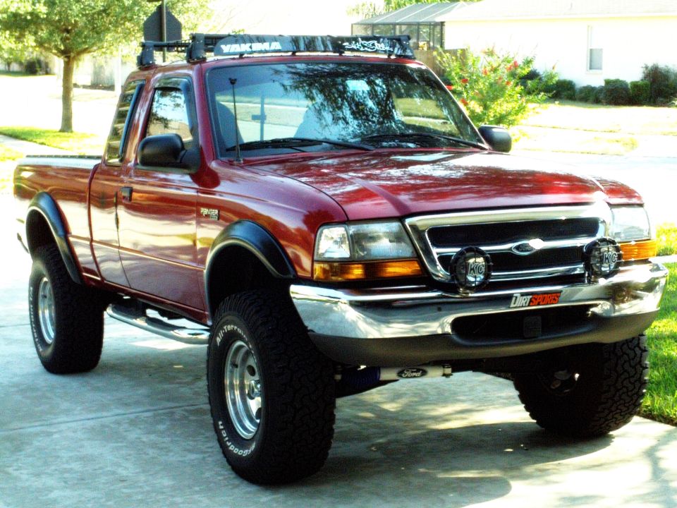 1999 Ford Ranger pickup truck with Yakima roof rack, aftermarket lights, and BFGoodrich tires