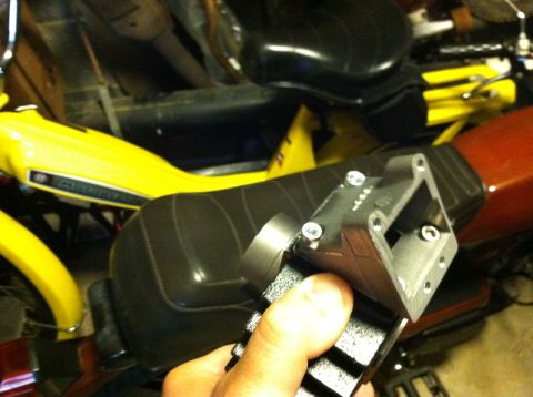 1981 Garelli Rally Sport - A hand holds a motorcycle intake manifold over a yellow and red moped, with other vehicles in the background.