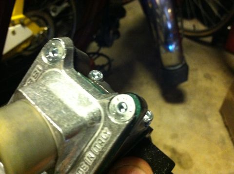 1981 Garelli Rally Sport - A metal component, likely from a motorcycle, is shown with visible screws and stamped text.