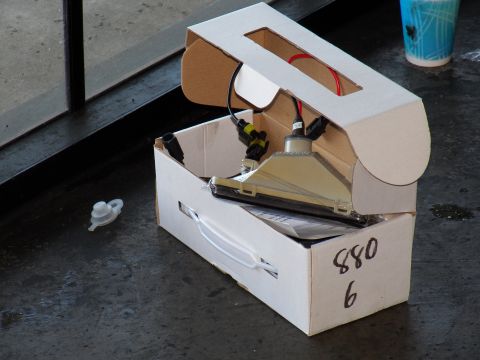 2003 Ford Crown Victoria - chrome lighting assembly sits in an open cardboard box hand-labeled 880 6.