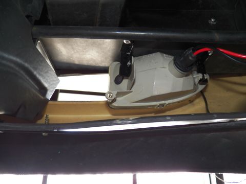 2003 Ford Crown Victoria - boxy lighting component sits bolted within the front structure of a vehicle.