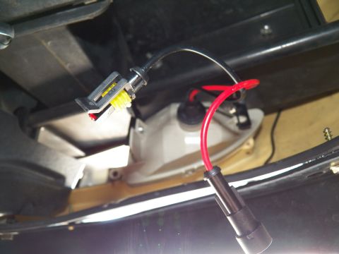 2003 Ford Crown Victoria - Close-up of a sealed bullet connector and red lead joined to a lighting housing.