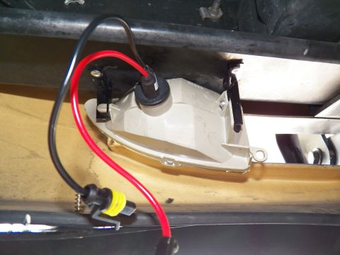 2003 Ford Crown Victoria - Empty headlight housing and routed wiring visible against a tan painted body.