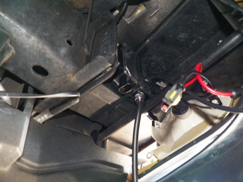 2003 Ford Crown Victoria - Black ballast box with red and black leads installed near a green body panel.