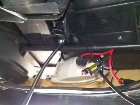 2003 Ford Crown Victoria - Lighting housing rear showing bulb socket and red-black wiring against tan paint.