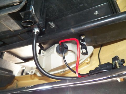 2003 Ford Crown Victoria - Close underbody shot of red and black leads beside a white housing and a black weatherproof connector