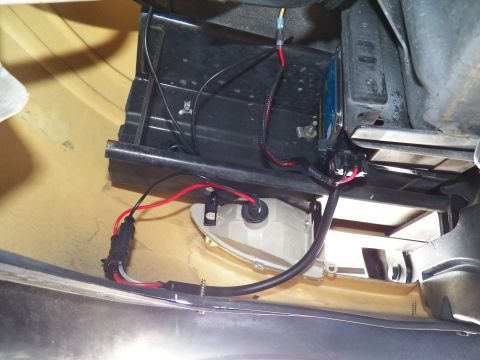 2003 Ford Crown Victoria - Black ballast with red and black leads wired to a white round housing inside a body cavity