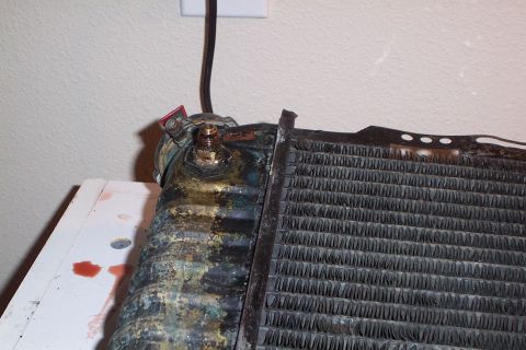 1980 Ford Bronco - Radiator part shown with corrosion and some leaked red fluid.