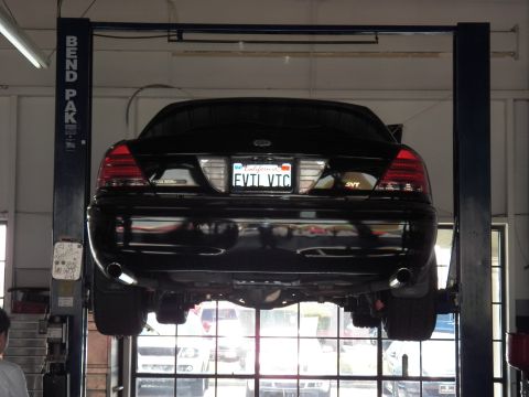 2003 Ford Crown Victoria - Black Crown Victoria raised on a BendPak hoist, tinted taillights and SVT badge at rear