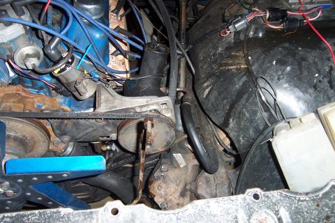 1980 Ford Bronco - Close-up view of a vehicle's engine compartment, showing various mechanical components and wiring.