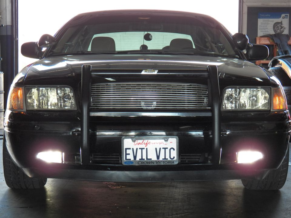 Black Ford Crown Victoria front close-up with grille guard and EVIL VIC plate