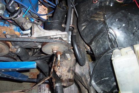 1980 Ford Bronco - Close-up view of engine compartment components including belts and pulleys.
