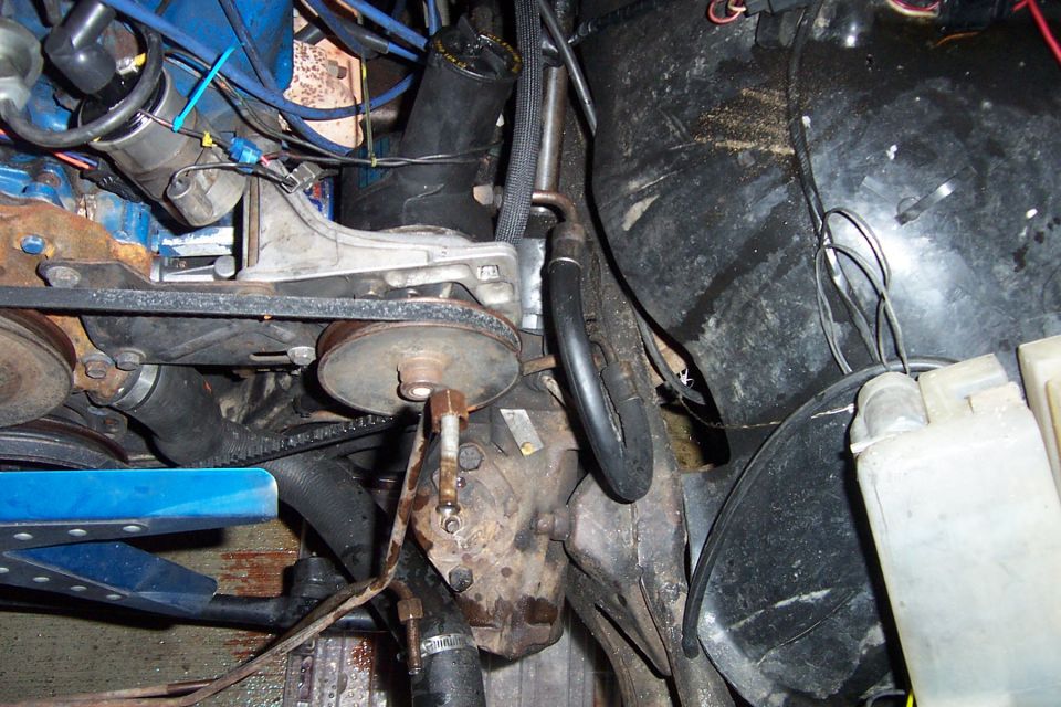 Engine compartment with belts and pulleys