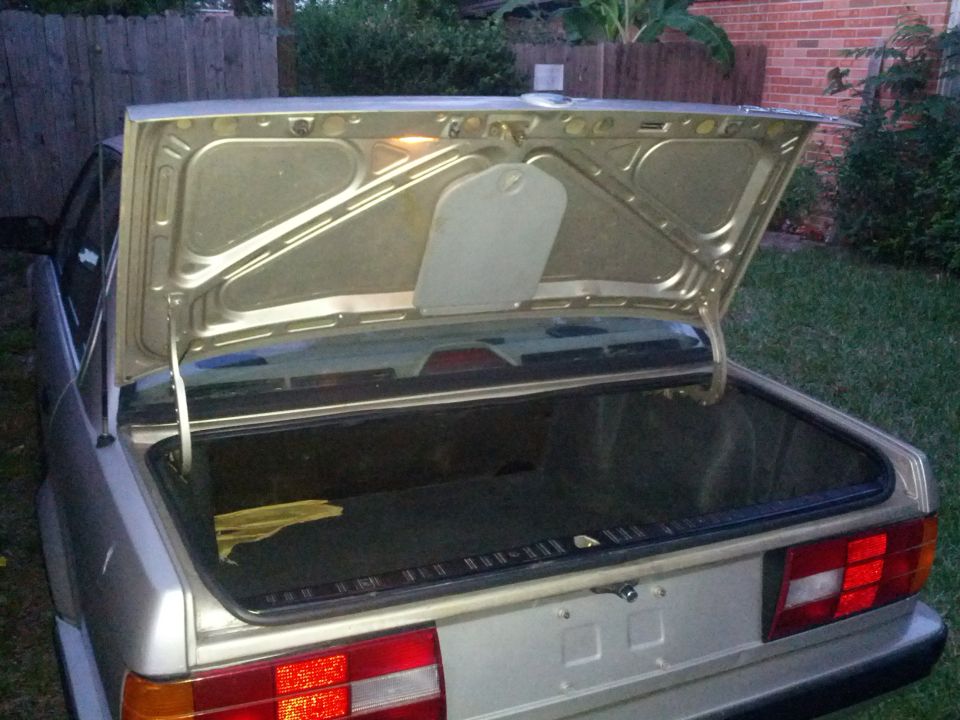 1989 BMW 3 Series trunk open, showing interior and rear bumper with taillights