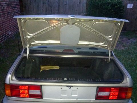 1989 BMW 3 Series - The trunk of a 1989 BMW 3 Series sedan is open, revealing the cargo area and the rear exterior.