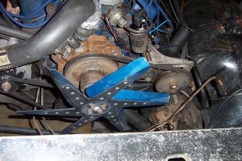 1980 Ford Bronco - Engine bay showing a blue-painted cooling fan, water pump pulley, belts and hoses on a V-engine.