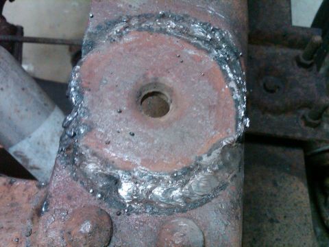 1986 Ford Bronco - A close-up view of a metal component that has been welded, showing signs of rust and wear.
