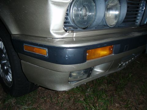 1989 BMW 3 Series - Front view of a gold 1989 BMW 3 Series showing the bumper, headlights, and turn signals.
