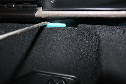 2003 Ford Crown Victoria - Tool used to pry blue foam insulation in a car's interior.