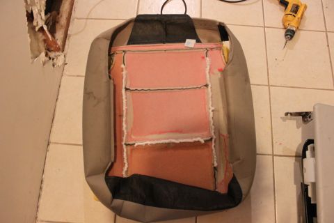 2003 Ford Crown Victoria - The interior of a car seat is visible, showing foam and fabric layers, with a drill nearby.