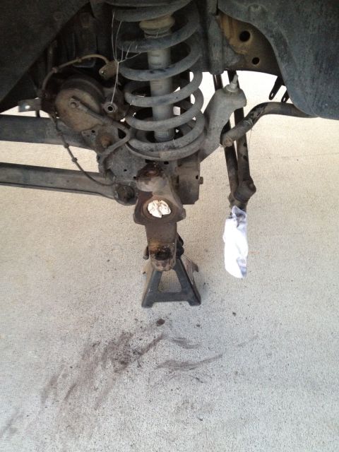 1997 Dodge 2500 - Close-up of a vehicle's suspension system, showing parts like the brake caliper and coil spring.