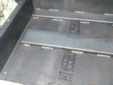 1988 Ford E350 - Close-up of a metal cargo area with visible welds and stenciled identification numbers.