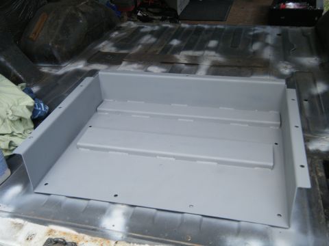 1988 Ford E350 - New gray metal floor insert installed in the cargo area of a van.