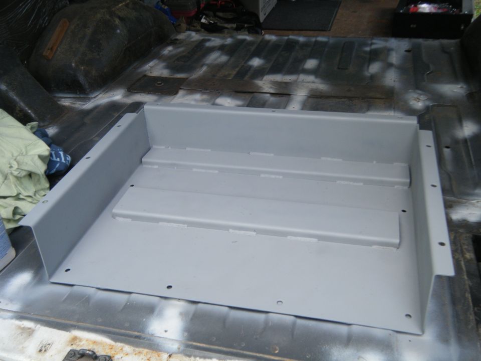 Gray metal floor insert in van interior