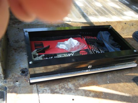 1988 Ford E350 - Tool chest filled with wrenches and other tools, placed inside a vehicle's cargo area.