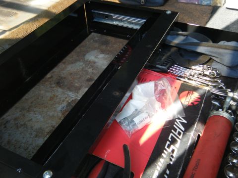 1988 Ford E350 - A close-up view of an open tool chest drawer filled with various tools and supplies.
