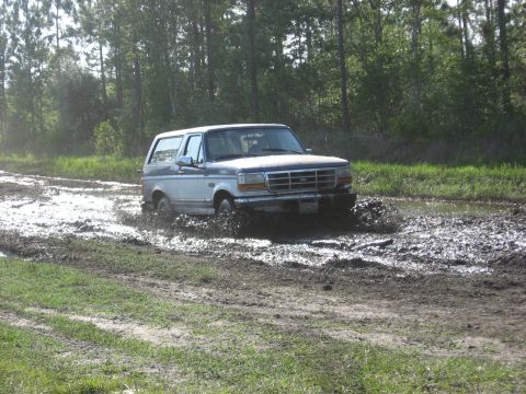 1994 Ford Bronco - This Ford Bronco is navigating a challenging muddy terrain.