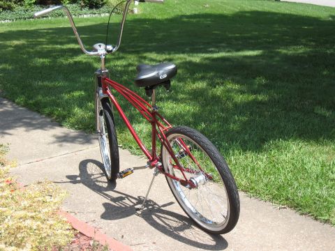 1994 Ford Bronco - Cruiser bicycle with chrome handlebars and white-wall tires on a sunny day.