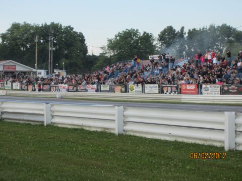 2004 Aston Martin Virage - Spectators fill the stands at a drag strip, with a date stamp indicating the event occurred on June 2, 2012.