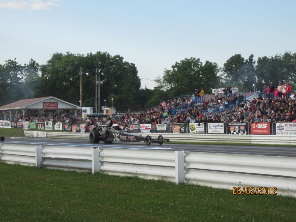 Dragster on a race track with spectators in the background