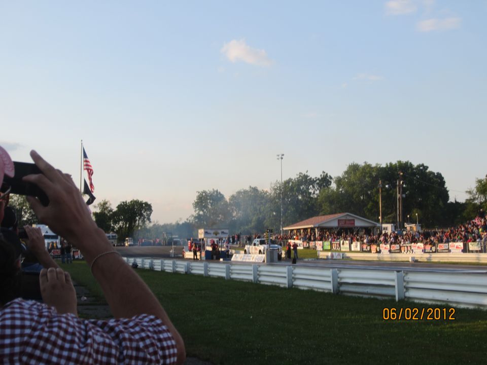 Drag strip with spectators and cars on the track, dated 06/02/2012