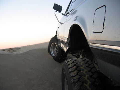 1989 Ford Bronco - This 1989 Ford Bronco is captured in a low-angle shot as it navigates sandy terrain.