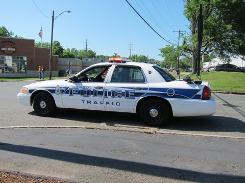 1991 Ford LTD Crown Victoria - white-and-blue East Hartford Police Ford Crown Victoria traffic cruiser viewed from the side along a roadway.