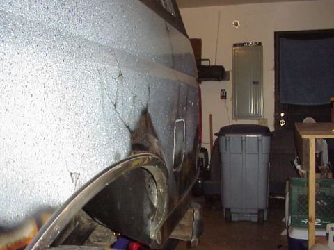 1989 Ford Bronco - The side of a 1987 Ford Bronco shows significant body damage and cracking paint.