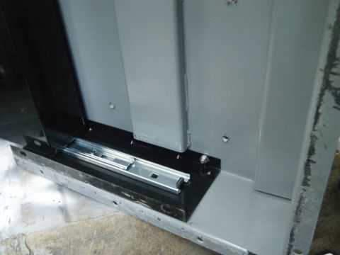 1988 Ford E350 - Close-up of a metal drawer slide mechanism, part of a larger assembly.