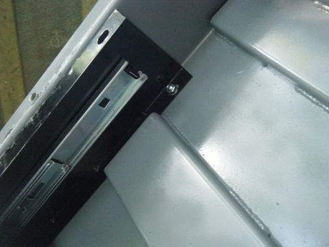 1988 Ford E350 - Close-up view of a metal drawer slide mechanism, likely from a van's interior storage.