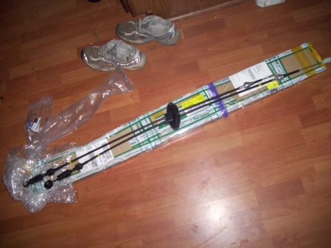 2003 Hyundai Tiburon - Unpacked vehicle control cables are laid out on a wooden floor next to a pair of athletic shoes.