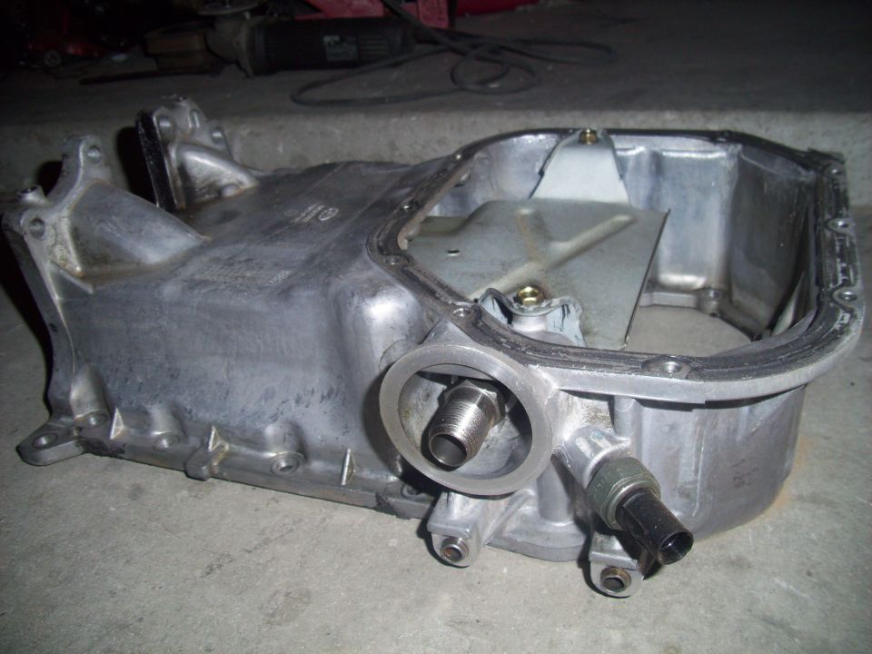 Oil pan with threaded fitting and sensor