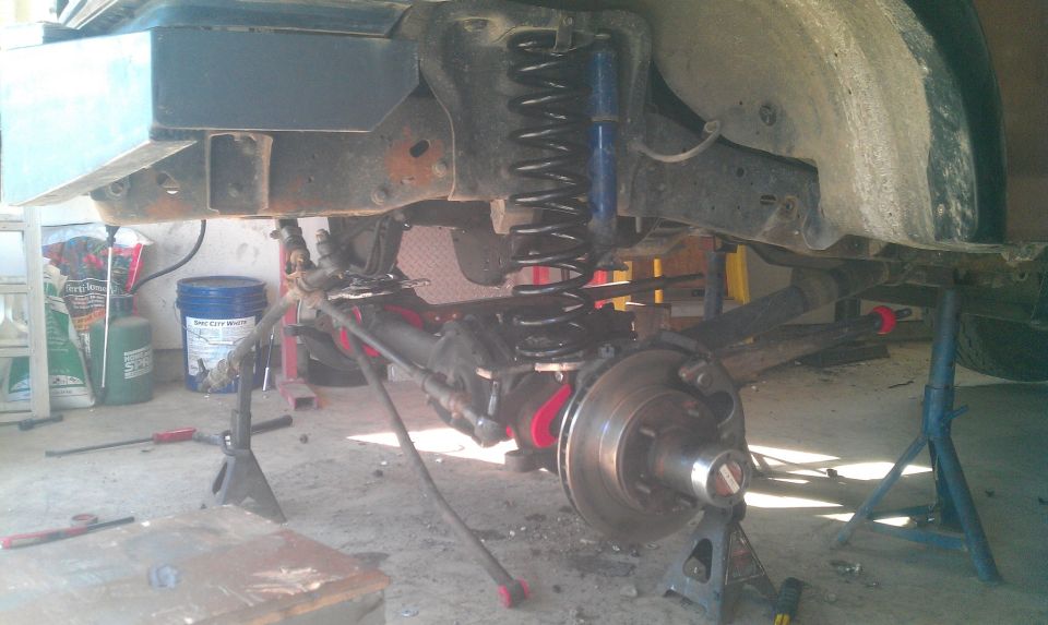 Close-up of vehicle suspension components on jack stands