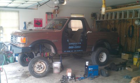 1987 Ford Bronco - This 1987 Ford Bronco is in a garage, appearing to be undergoing some work or modification.
