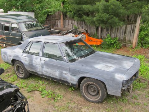 1991 Ford LTD Crown Victoria - This Ford Crown Victoria is in primer and appears to be undergoing restoration or repair.