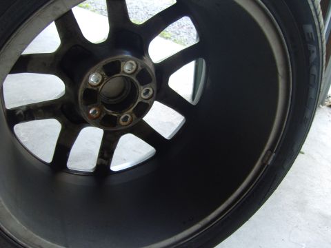 2007 Ford Mustang - A close-up view of a single car wheel, showing its intricate spoke design and tire.