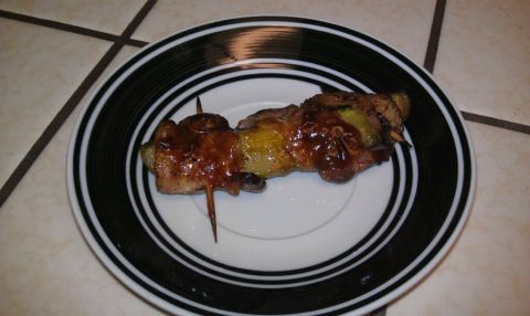1989 Ford Bronco - A close-up of a glazed food skewer resting on a decorative plate.