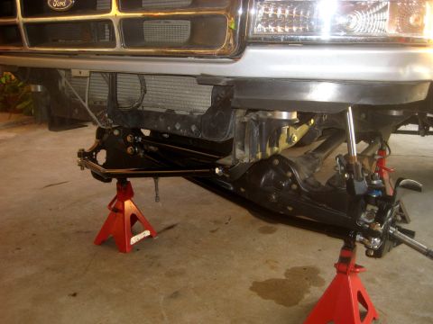 1996 Ford Bronco - Front suspension and steering components are visible as the vehicle is supported by jack stands.